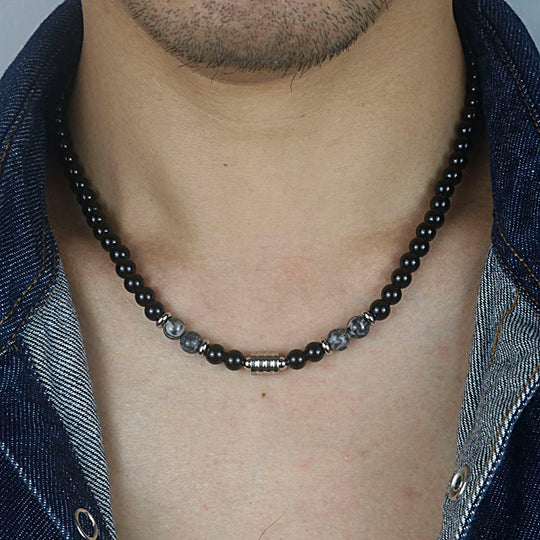 A stainless steel necklace of beads combined with the eye of the tiger