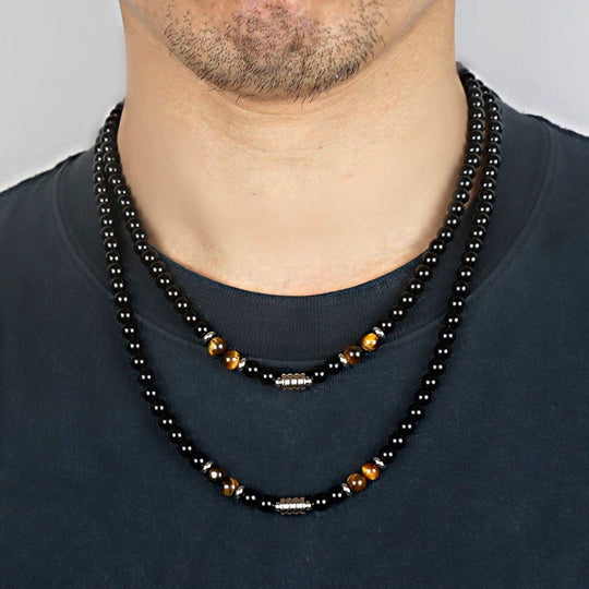 A stainless steel necklace of beads combined with the eye of the tiger