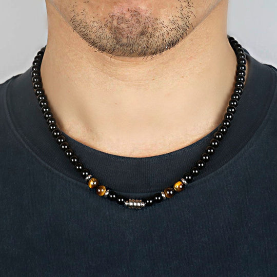 A stainless steel necklace of beads combined with the eye of the tiger